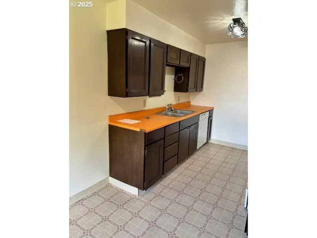 a kitchen with stainless steel appliances a sink and a microwave