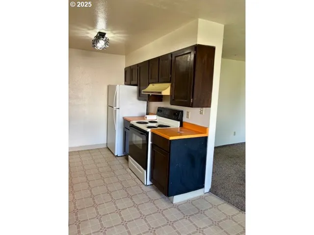 a kitchen with stainless steel appliances a stove and a microwave