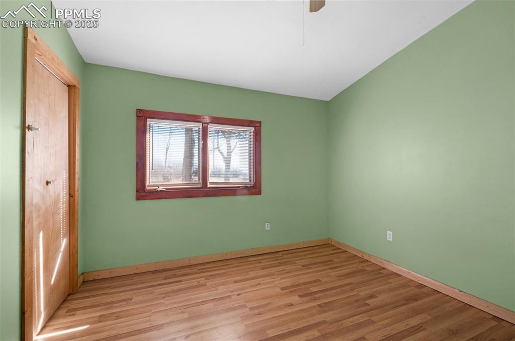 27720 Mid Jones Road Calhan, CO 80808 - Photo 13 of 43 a view of empty room with wooden floor and fan