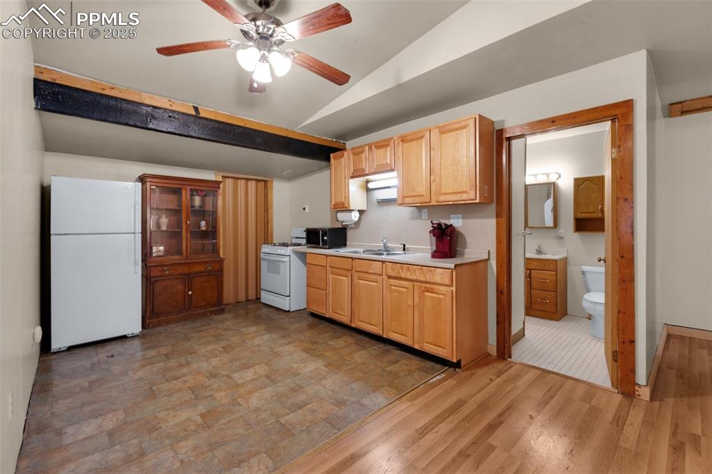 27720 Mid Jones Road Calhan, CO 80808 - Photo 26 of 43 a kitchen with stainless steel appliances a stove a refrigerator a sink a oven with a dining table and chairs