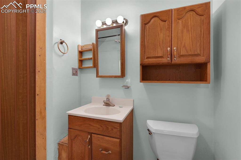 27720 Mid Jones Road Calhan, CO 80808 - Photo 33 of 43 a bathroom with a toilet sink and mirror