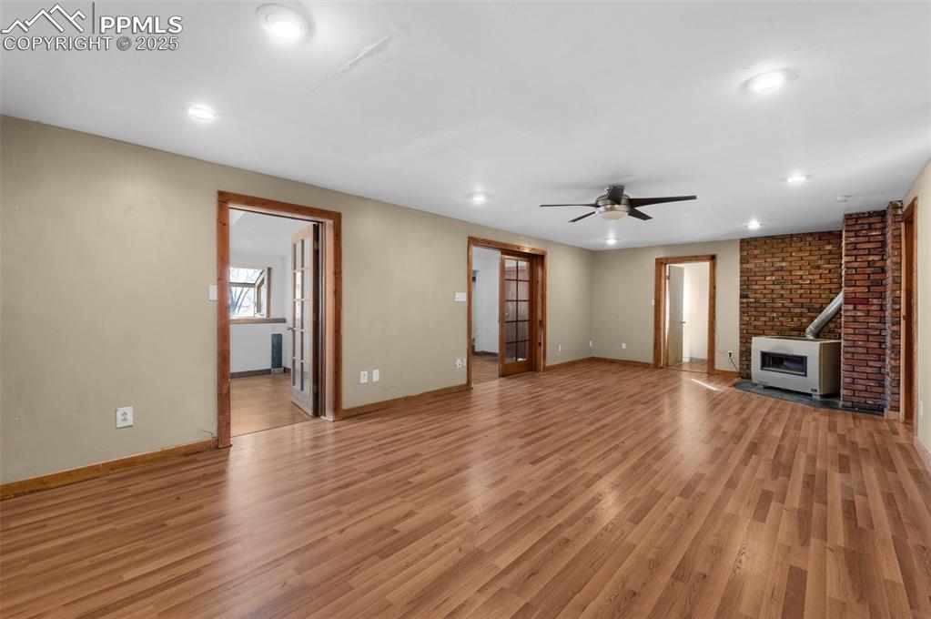 27720 Mid Jones Road Calhan, CO 80808 - Photo 9 of 43 a view of a big room with wooden floor and windows
