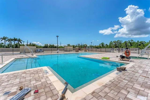 a view of a house with a swimming pool and a yard