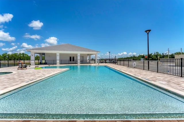 a view of a swimming pool with an outdoor space and seating area