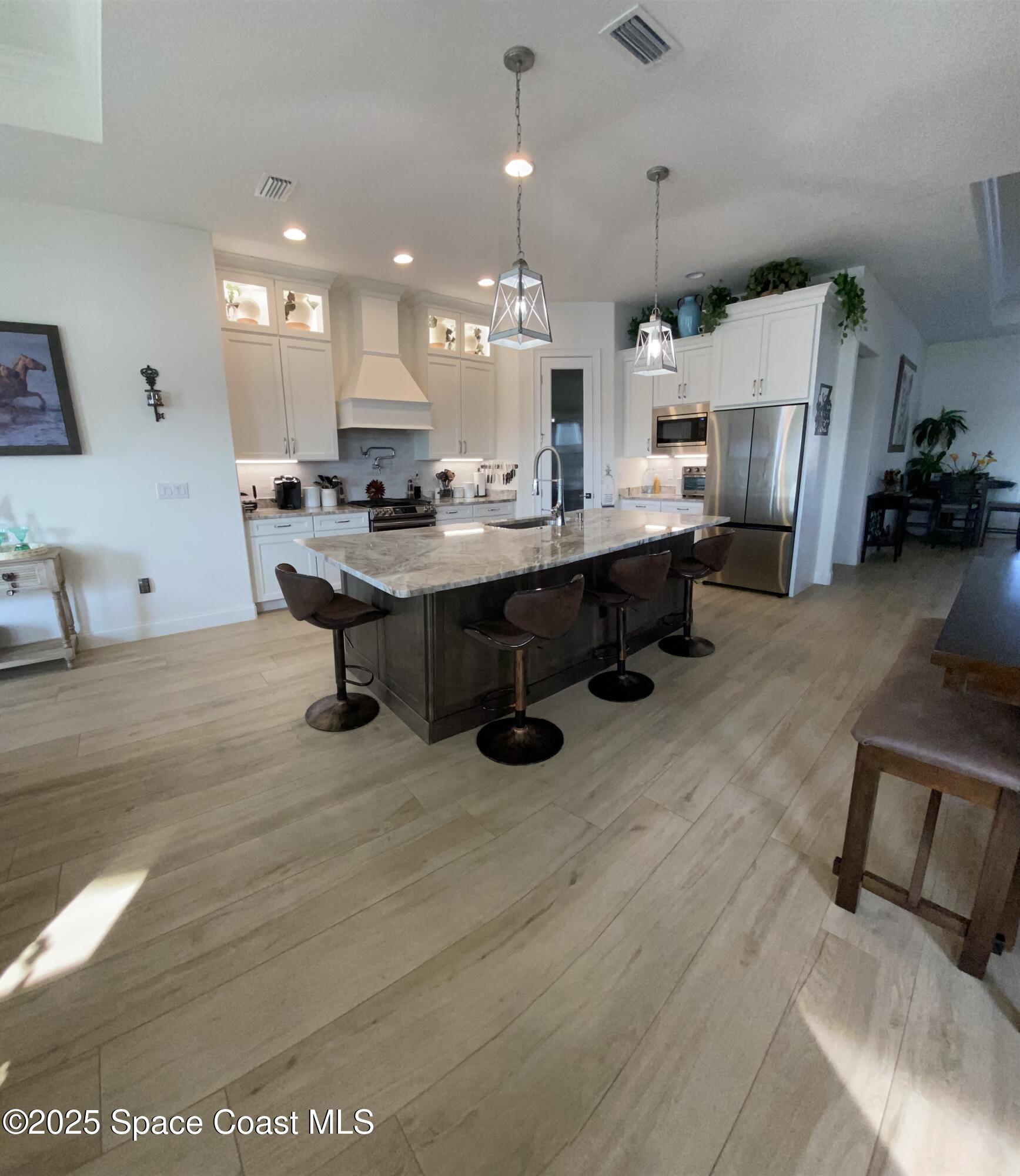 4290 Negal Circle Melbourne, FL 32901 - Photo 5 of 6 a large kitchen with lots of counter space and painting on the wall