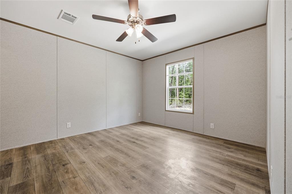 150 19th Street Interlachen, FL 32148 - Photo 21 of 30 an empty room with windows and fan