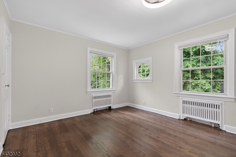 180 Summit Avenue, Unit B Summit, NJ 07901 - Photo 12 of 15 an empty room with wooden floor and windows