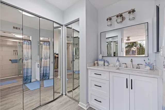 a bathroom with a double vanity sink mirror and shower