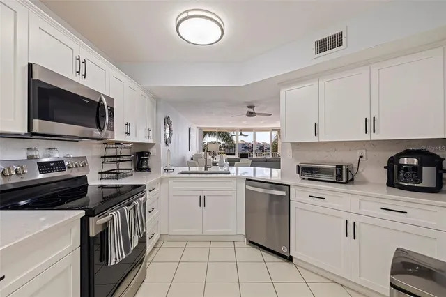 a kitchen with cabinets stainless steel appliances and a counter space