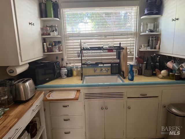 618 Benton Street Santa Rosa, CA 95404 - Photo 4 of 27 a kitchen with a sink and cabinets