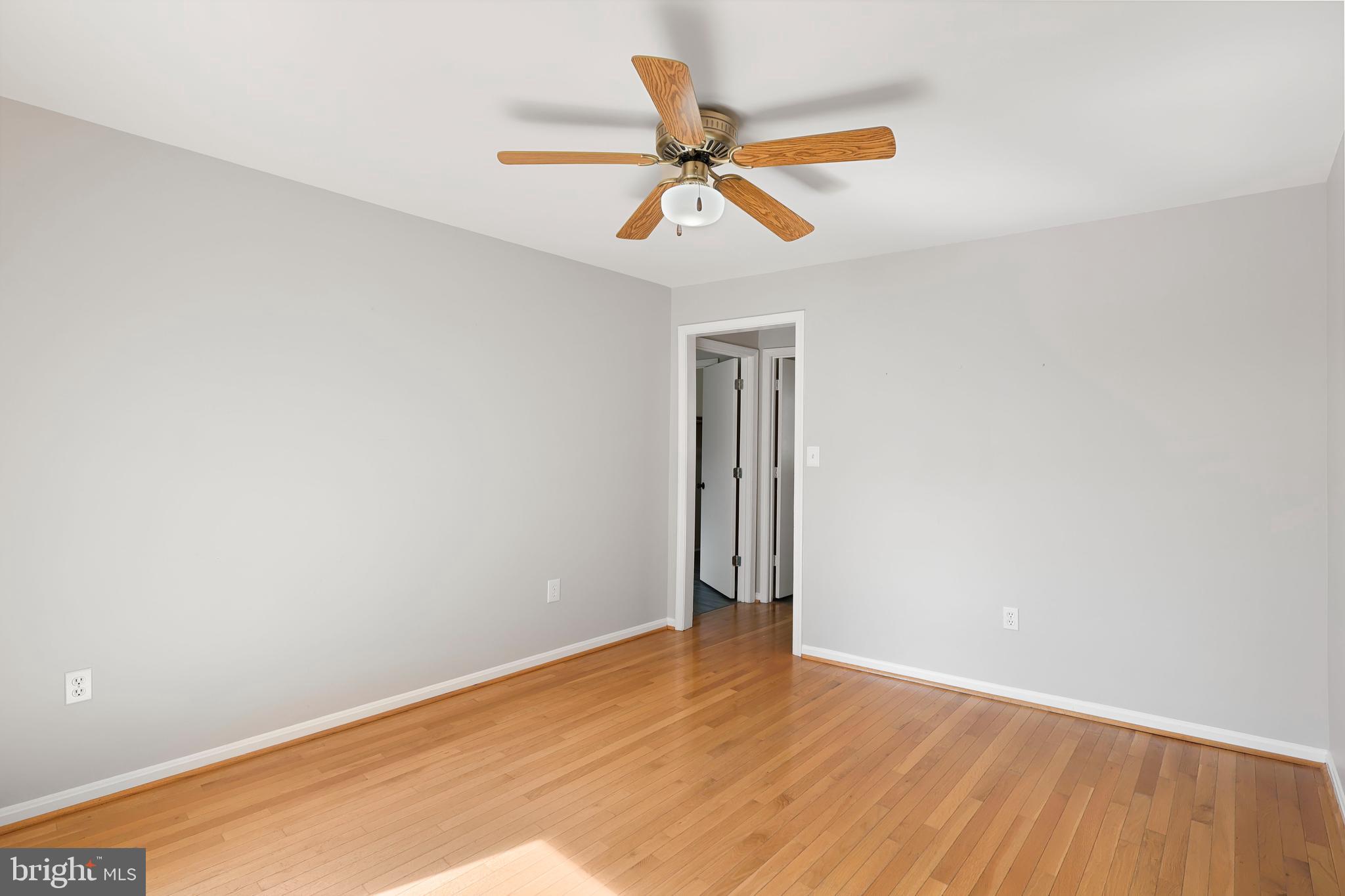 15366 Black Hill Road Rixeyville, VA 22737 - Photo 16 of 35 an empty room with wooden floor ceiling fan and window