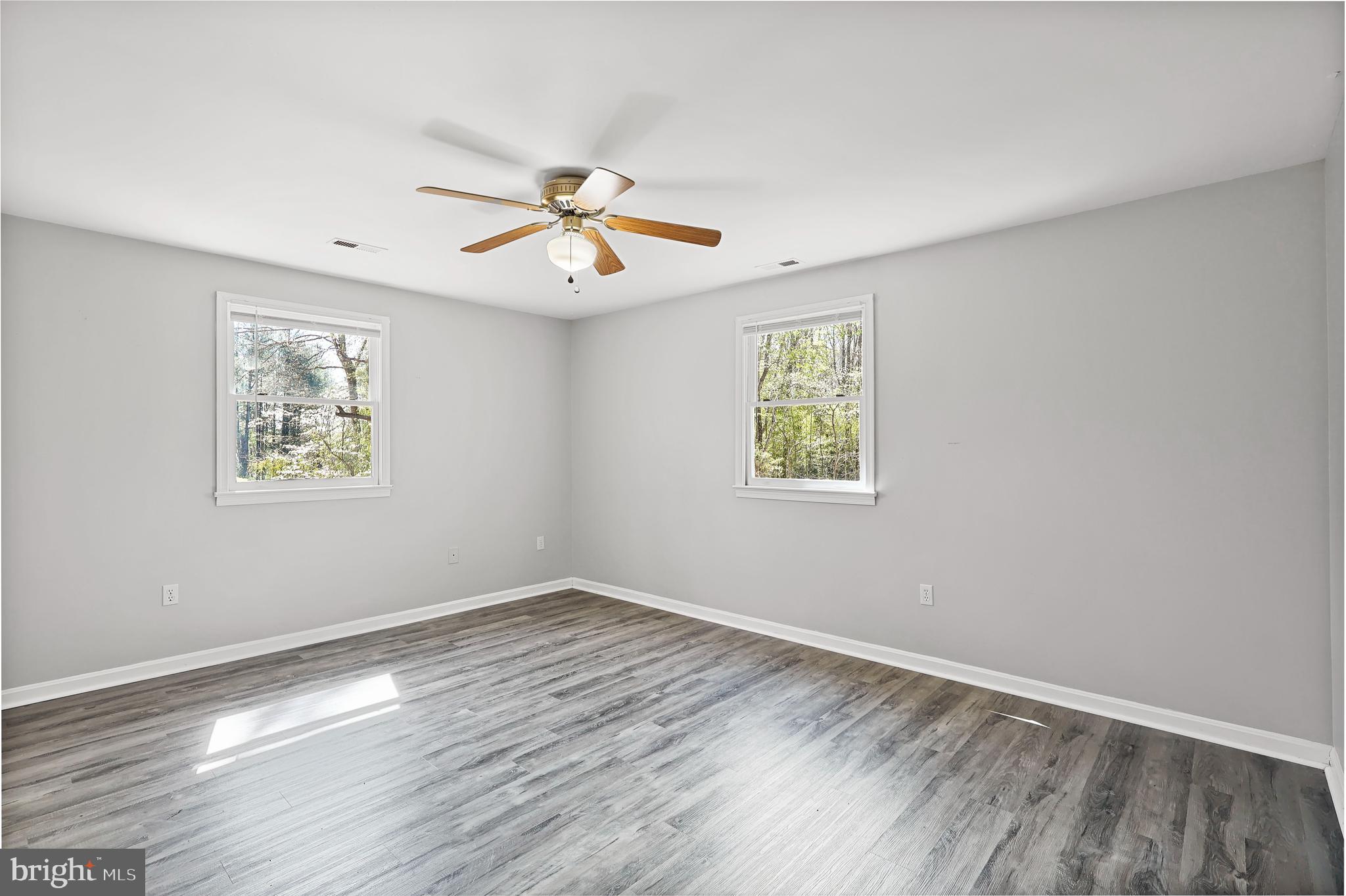 15366 Black Hill Road Rixeyville, VA 22737 - Photo 19 of 35 a view of empty room with wooden floor and fan