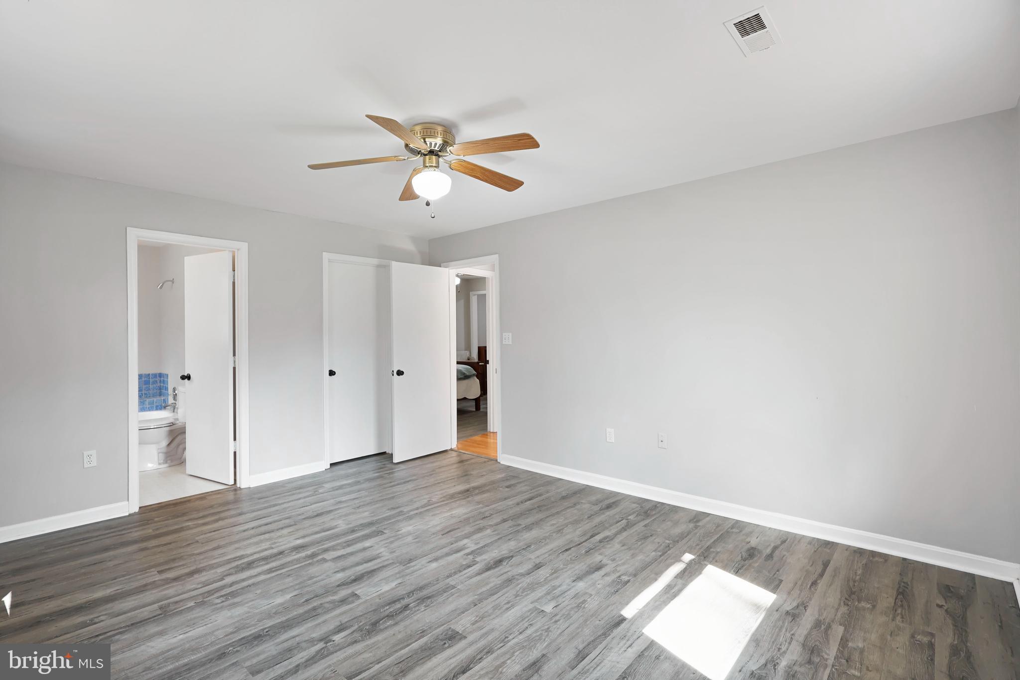 15366 Black Hill Road Rixeyville, VA 22737 - Photo 20 of 35 a view of a room with wooden floor and ceiling fan