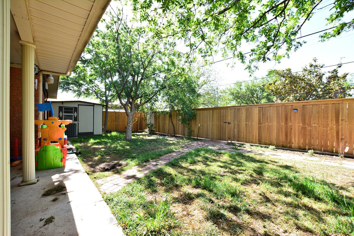 4903 17th Street Lubbock, TX 79416 - Photo 24 of 25 a backyard of a house with green landscape