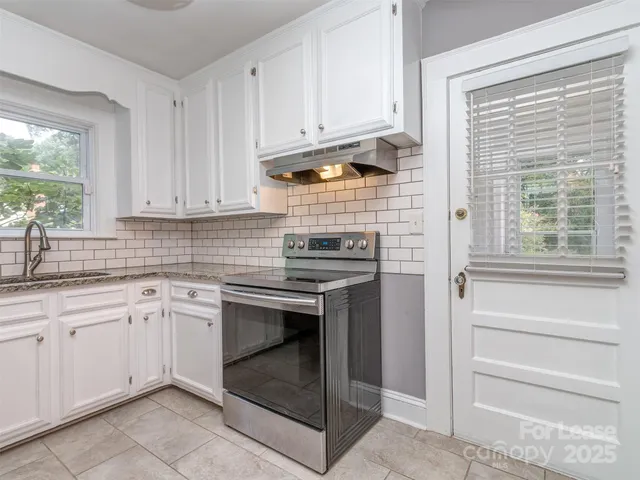 a kitchen with cabinets appliances and a sink