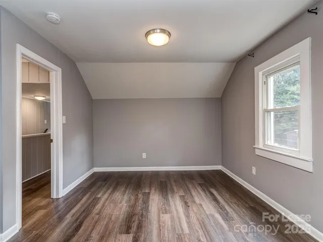 a view of room with window and hardwood floor