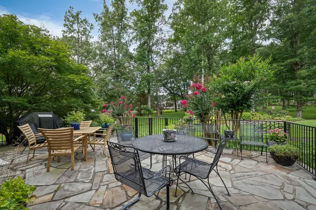 a view of a dining room with furniture and chandelier
