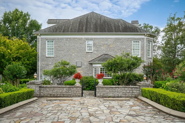 a bathroom with a granite countertop sink toilet and mirror