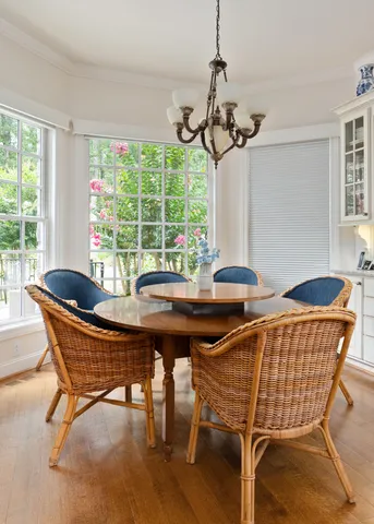 a living room with furniture a flat screen tv and a floor to ceiling window