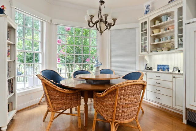 a bedroom with a bed bookshelf and a large window