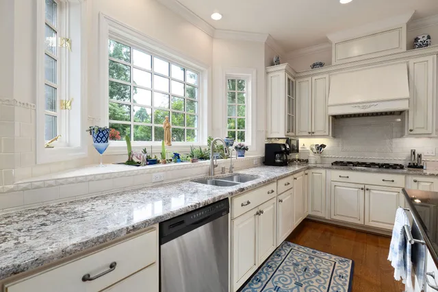 a living room with furniture a rug and a large window
