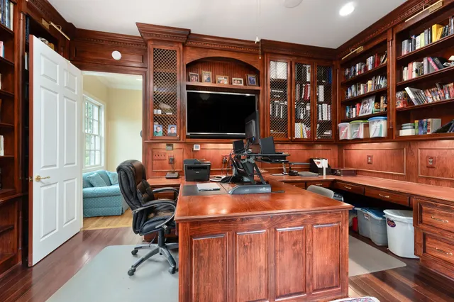 a bedroom with a bed a table and a large mirror