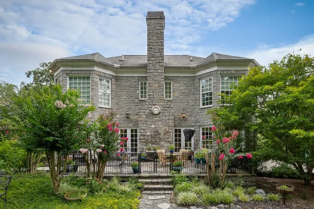 a view of a patio with a table and chairs