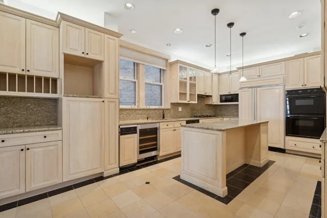 a kitchen with stainless steel appliances white cabinets and a refrigerator