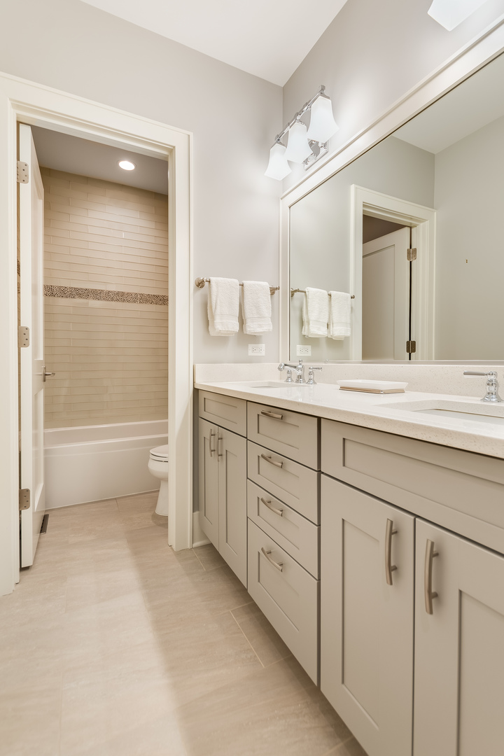 1480 West Grace Street Chicago, IL 60613 - Photo 24 of 41 a bathroom with a granite countertop sink mirror and
