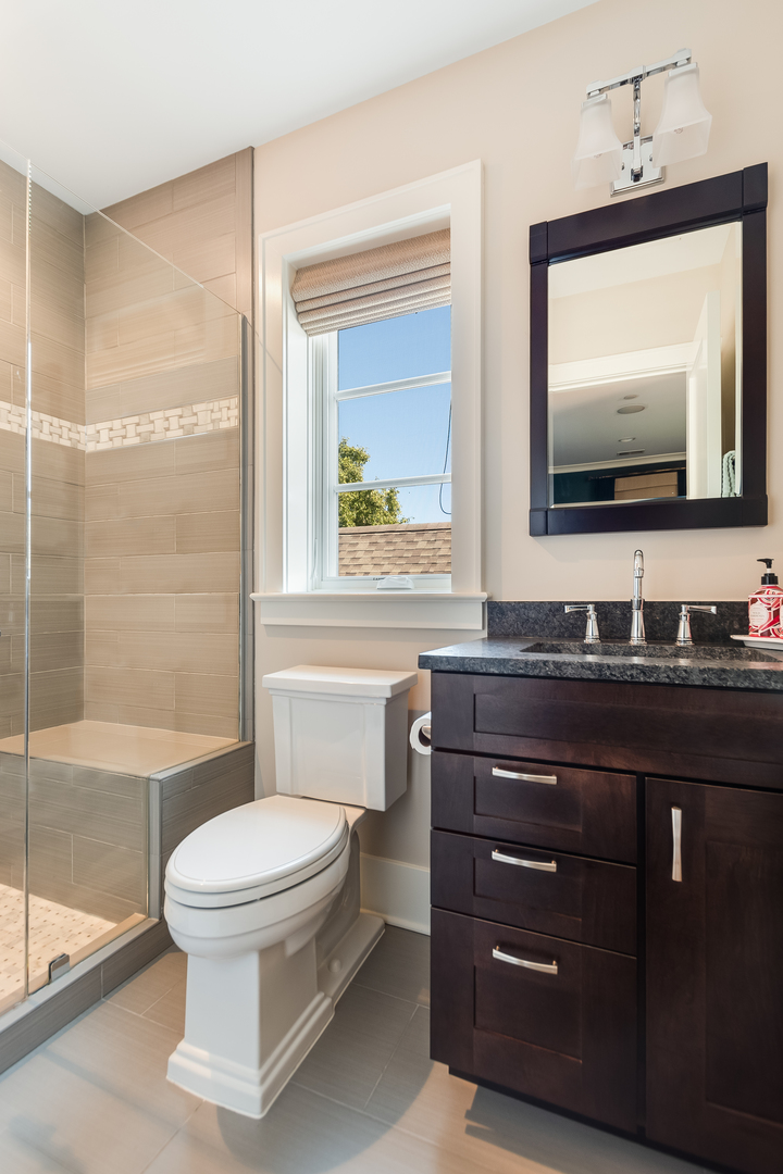 1480 West Grace Street Chicago, IL 60613 - Photo 29 of 41 a bathroom with a toilet a sink and a mirror