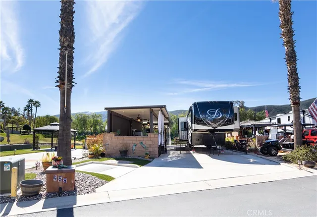 a living room with furniture a flat screen tv and a floor to ceiling window