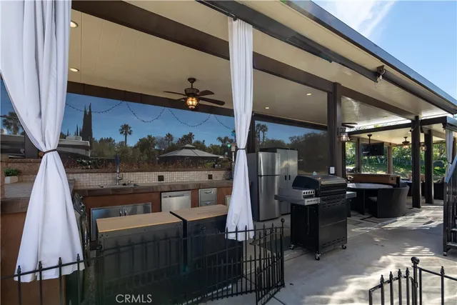 a view of a patio with a dining table and chairs