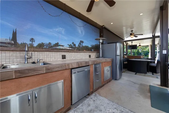 a view of a kitchen with a sink and a stove top oven
