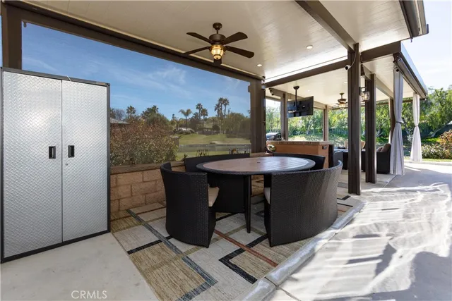 a dining room with furniture and a floor to ceiling window