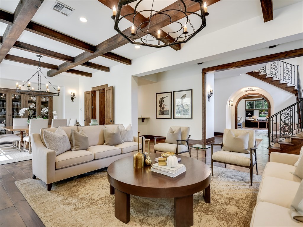 a living room with furniture a fireplace and a chandelier