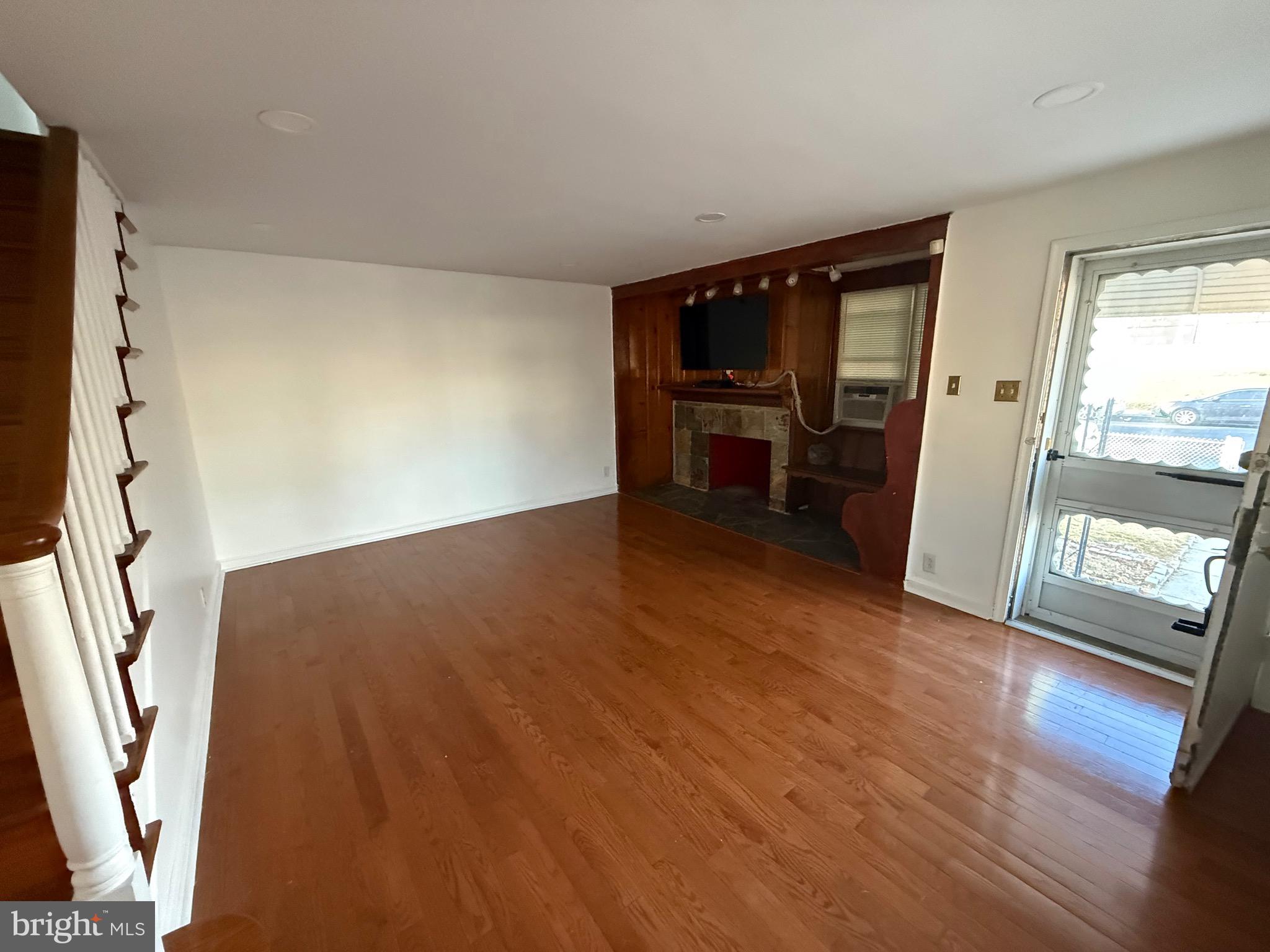 363 Sherbrook Boulevard Upper Darby, PA 19082 - Photo 2 of 12 wooden floor in an empty room with a window