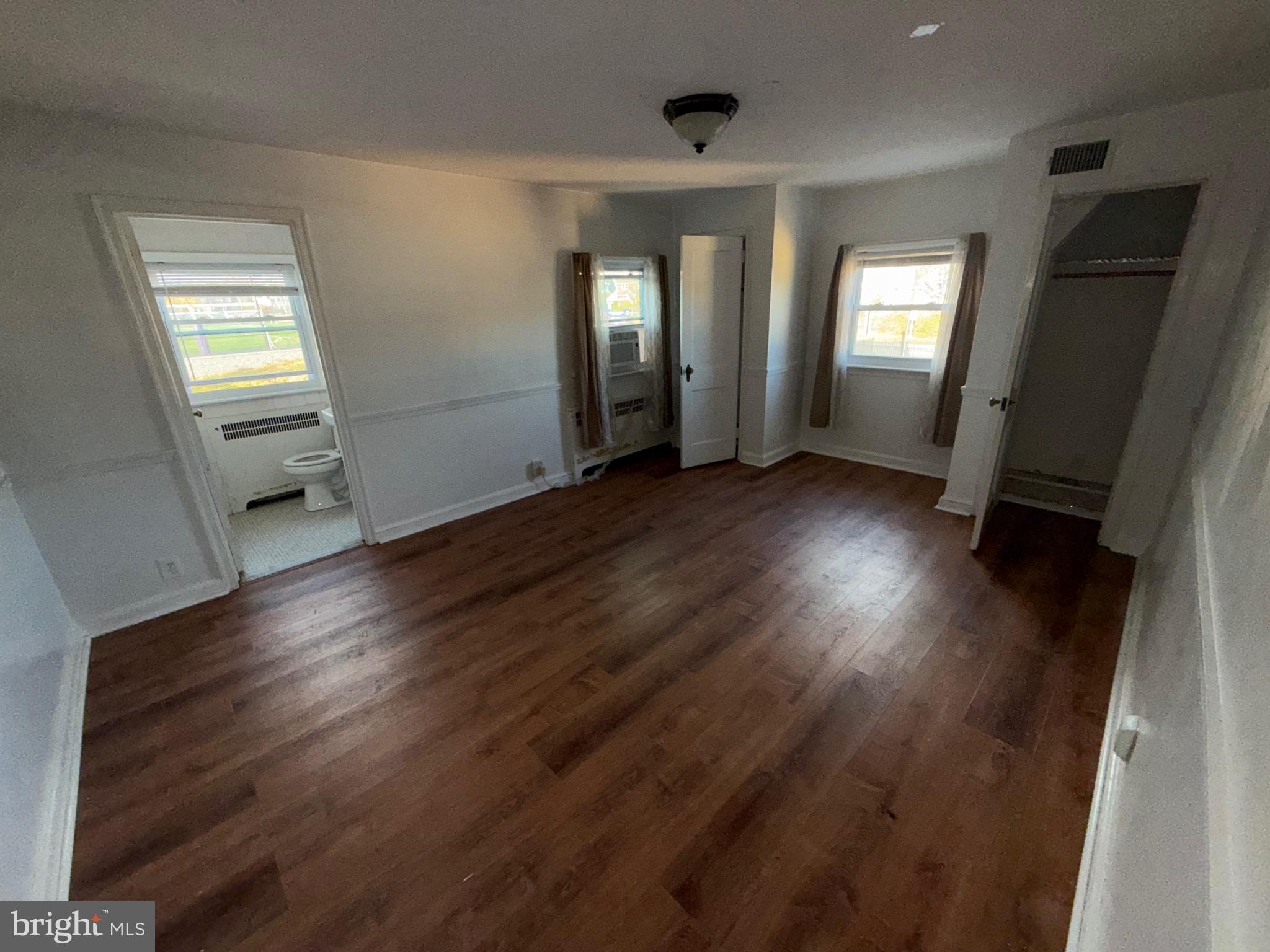 363 Sherbrook Boulevard Upper Darby, PA 19082 - Photo 8 of 12 a view of wooden floor and windows in an empty room