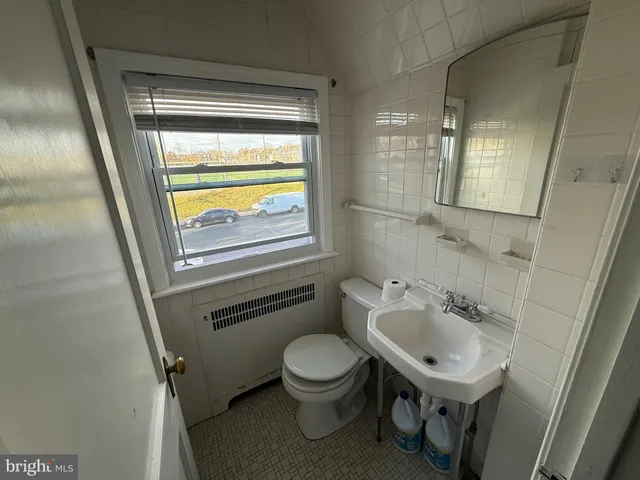 a bathroom with a sink a toilet and tub