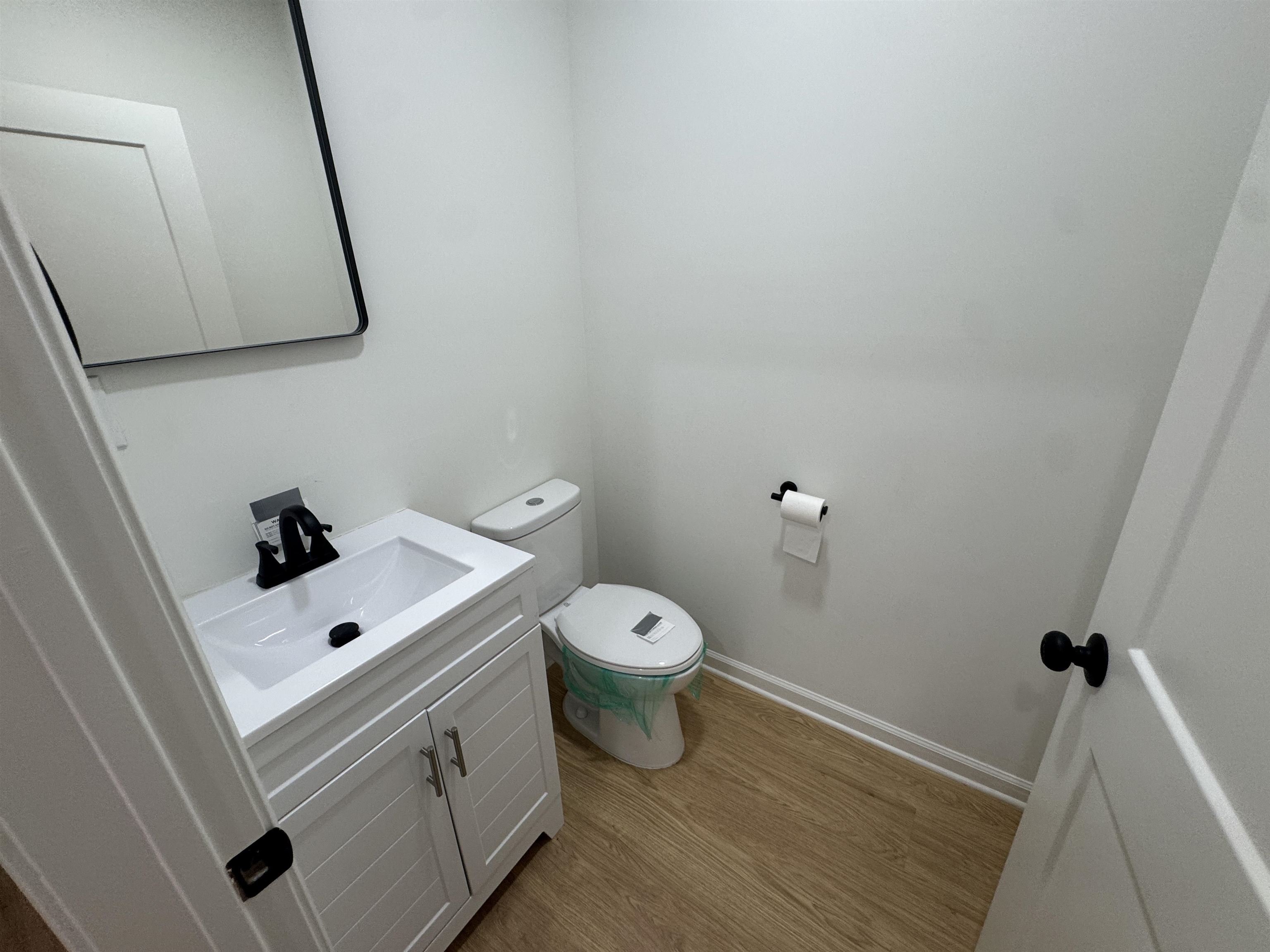 33 North Merton Street Memphis, TN 38112 - Photo 5 of 14 Half bathroom featuring vanity and light wood finished floors