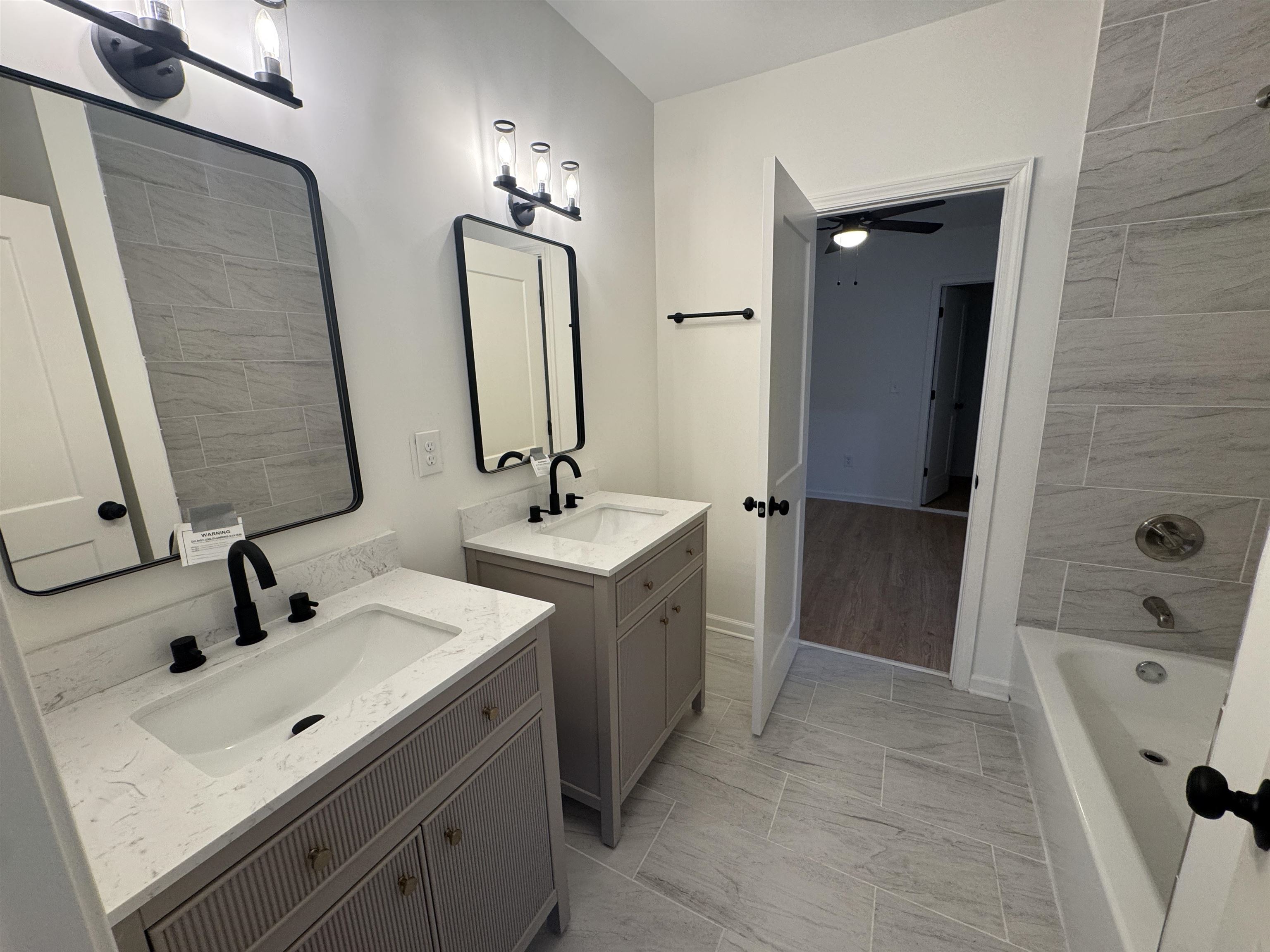 33 North Merton Street Memphis, TN 38112 - Photo 7 of 14 Full bath featuring two vanities, shower / bathtub combination, and a ceiling fan