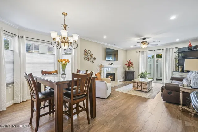 a view of a dining room with furniture wooden floor and chandelier