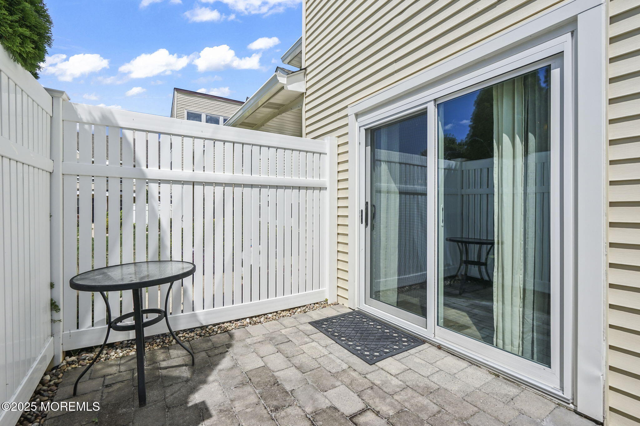 126 Wyckoff Mills Road, Unit 84 Hightstown, NJ 08520 - Photo 11 of 16 a view of a porch with a table and chairs