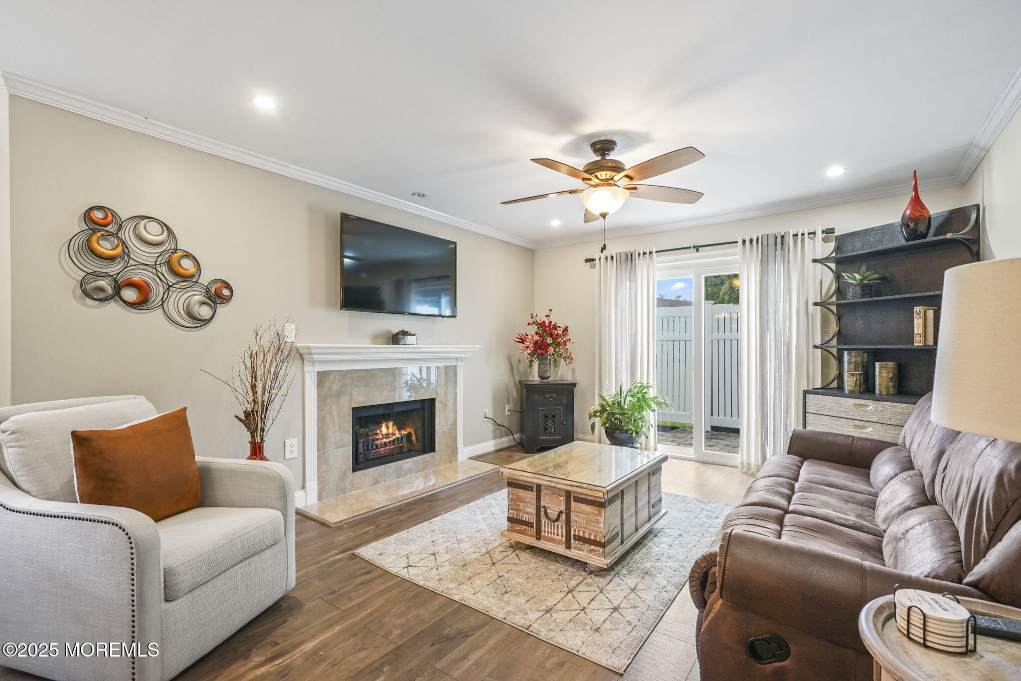 126 Wyckoff Mills Road, Unit 84 Hightstown, NJ 08520 - Photo 16 of 16 a living room with furniture fireplace and a flat screen tv