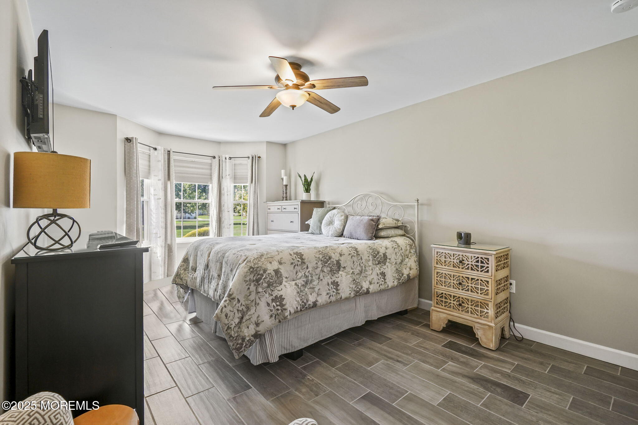 126 Wyckoff Mills Road, Unit 84 Hightstown, NJ 08520 - Photo 9 of 16 a bedroom with a bed and a chandelier