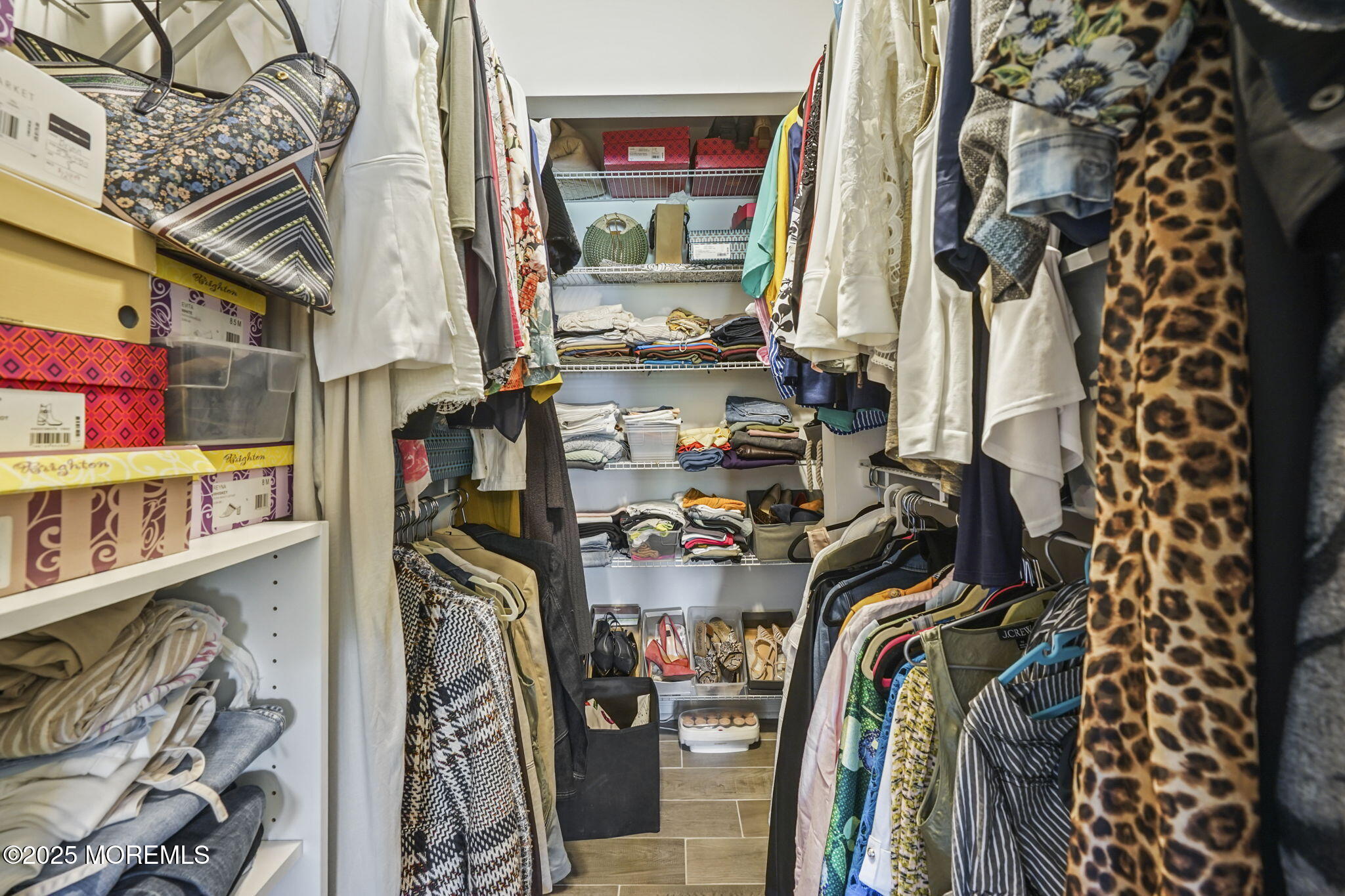126 Wyckoff Mills Road, Unit 84 Hightstown, NJ 08520 - Photo 10 of 16 a view of walk in closet with clothes and shoes