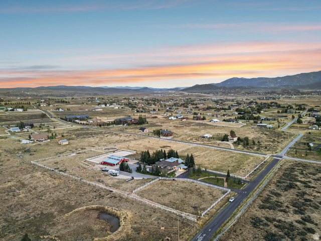 8650 Redden Road Park City, UT 84098 - Photo 62 of 71 Expansive property featuring a main residence, an additional structure with a red roof, fenced pastures, and a circular riding arena