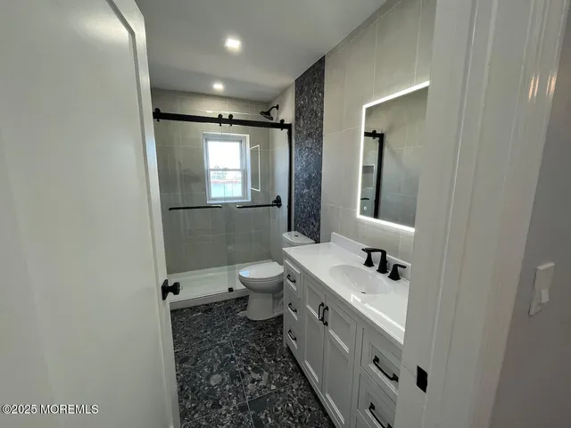 a bathroom with a toilet sink and mirror