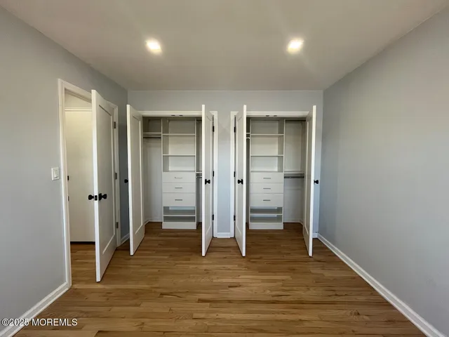 an empty room with wooden floor and closet