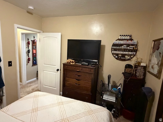 737 Wasatch Street Midvale, UT 84047 - Photo 10 of 29 Carpeted room featuring a white interior door with black hardware, neutral wall paint, and a built-in smoke detector