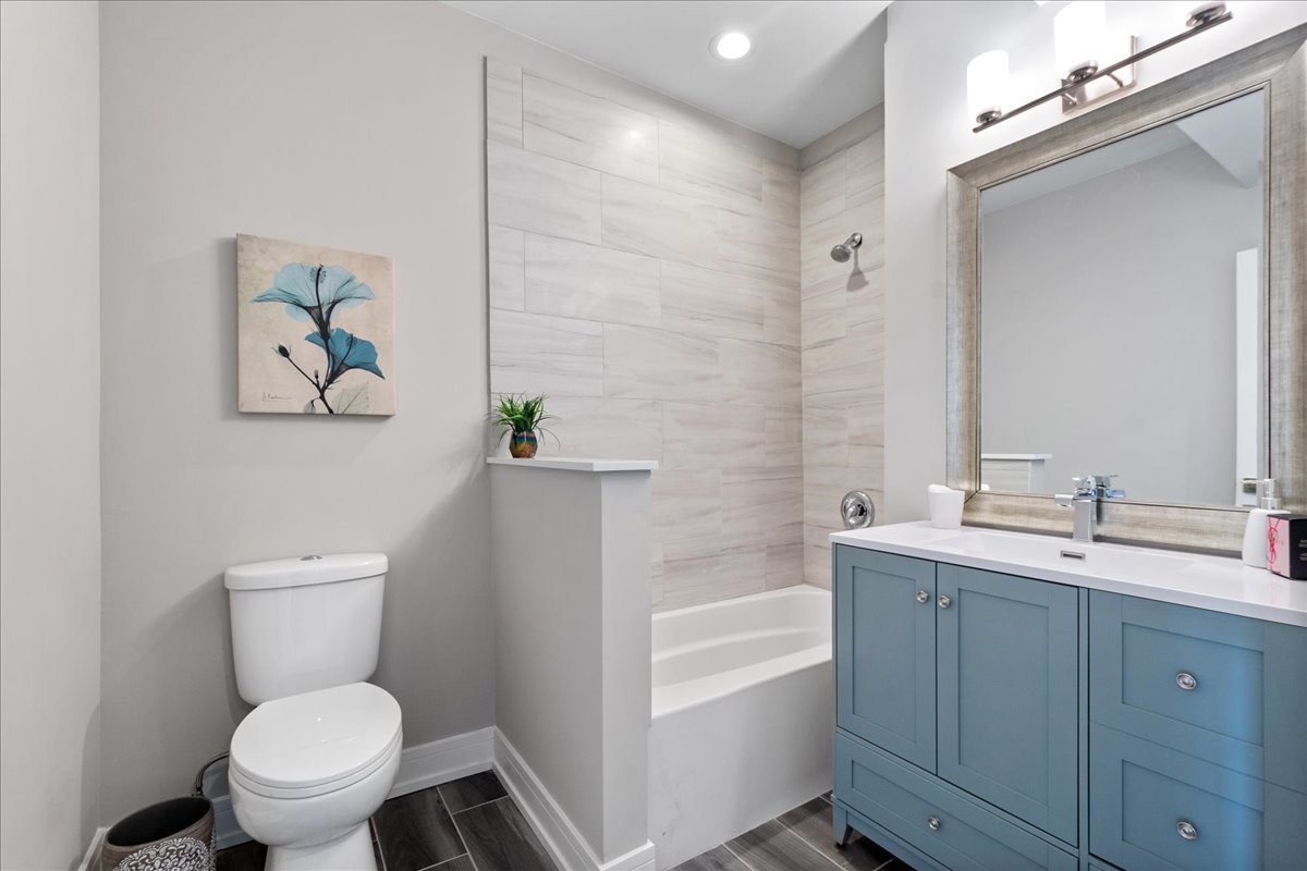 4855 West School Street Chicago, IL 60641 - Photo 15 of 29 a bathroom with a toilet sink and mirror